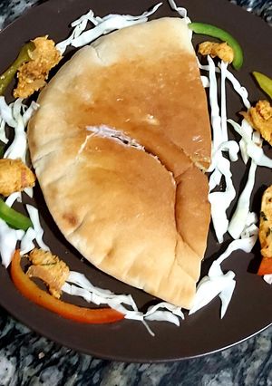 A picture of Chicken masala in pita bread.