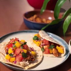 A picture of Honey chicken and brown rice tacos with a mango salsa.