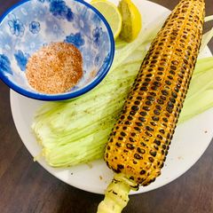A picture of Corn on the cob on stove.