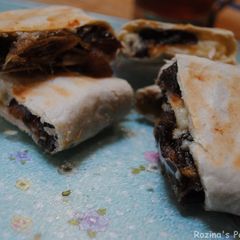 A picture of Mashed dates and cheddar cheese wrapped in bread.