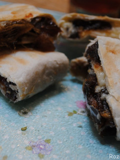 A picture of Mashed dates and cheddar cheese wrapped in bread.