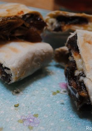 A picture of Mashed dates and cheddar cheese wrapped in bread.