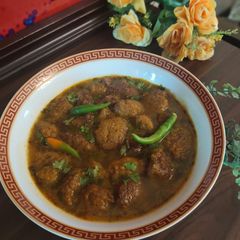 Moong daal Mangochian (fried lentils balls in curry) A picture of Moong daal Mangochian (fried lentils balls in curry).