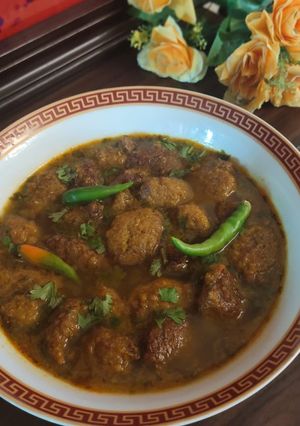 A picture of Moong daal Mangochian (fried lentils balls in curry).