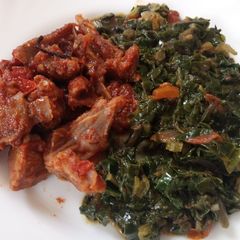 A picture of Wet fried goat meatwith spinach.