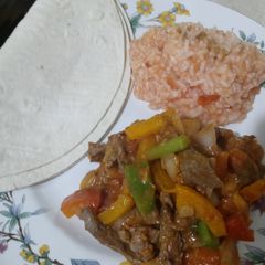 A picture of Steak Fajitas With In House Mexican Rice.