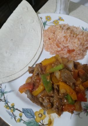 A picture of Steak Fajitas With In House Mexican Rice.