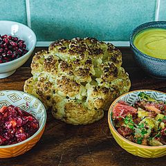 A picture of Whole roasted cauliflower with her bodyguards.