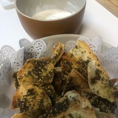 A picture of Zaatar bread chips with Yogurt dip.