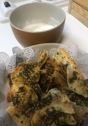 A picture of Zaatar bread chips with Yogurt dip.