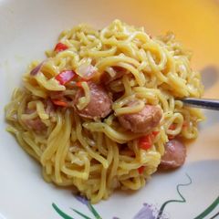 A picture of Indomie noodles with sausage.