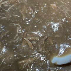 A picture of Cornbread Dressing with giblets gravy.