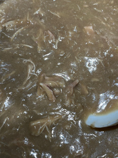 A picture of Cornbread Dressing with giblets gravy.