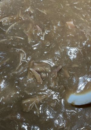 A picture of Cornbread Dressing with giblets gravy.