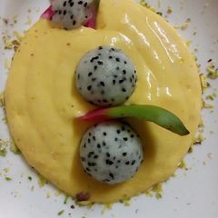 A picture of Mango cream serve with dragon fruit.