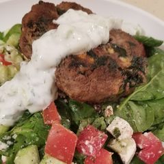A picture of Greek Burgers w/yogurt sauce.