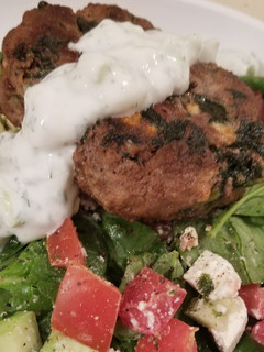 A picture of Greek Burgers w/yogurt sauce.