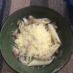 A picture of Pasta con pollo, champiñones y tocineta.