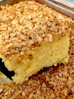 Una foto de Bizcocho de mandarina con cobertura de avellanas, almendras y cacahuetes 🍊🍰