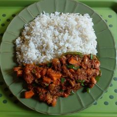 A picture of White rice and shrimps sauce.