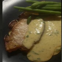 A picture of Pork Chops With Gorgonzola & Parsley sauce.