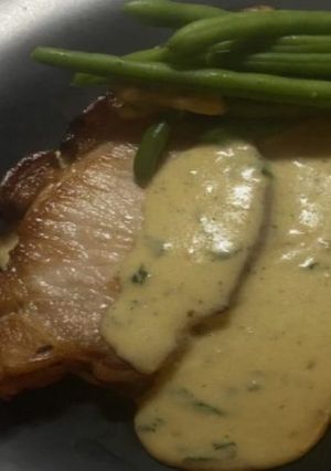 A picture of Pork Chops With Gorgonzola & Parsley sauce.