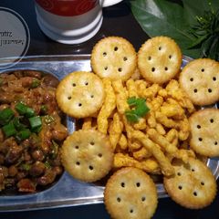 A picture of Peanuts salsa with kurkure and monaco biscuits.