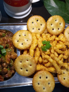 A picture of Peanuts salsa with kurkure and monaco biscuits.