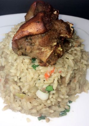 A picture of Coconut rice with fried goat meat.