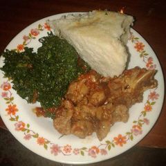 A picture of Wet fry Beef, sukuma wiki with Ugali.