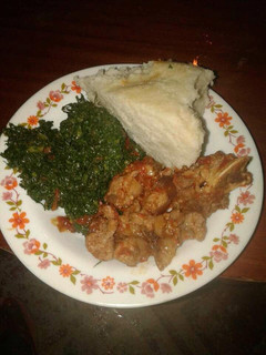 A picture of Wet fry Beef, sukuma wiki with Ugali.