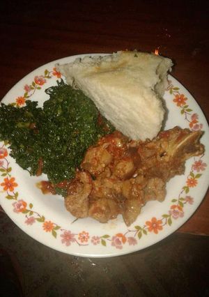 A picture of Wet fry Beef, sukuma wiki with Ugali.