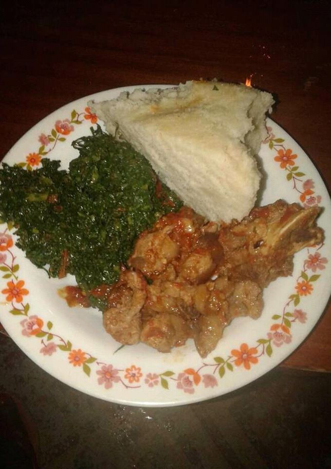A picture of Wet fry Beef, sukuma wiki with Ugali.
