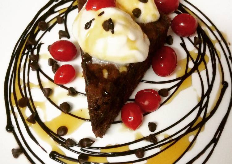 Chocolate brownie served with vanilla ice cream and maple syrup