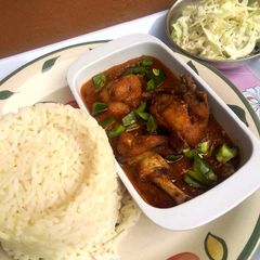 A picture of Orange rice, Chicken Stew and Creamy Cabbage Salad.