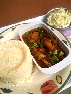 A picture of Orange rice, Chicken Stew and Creamy Cabbage Salad.