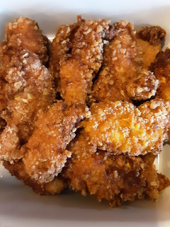 A picture of Pork rinds coated chicken fingers and shrimp.