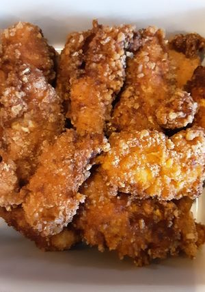 A picture of Pork rinds coated chicken fingers and shrimp.
