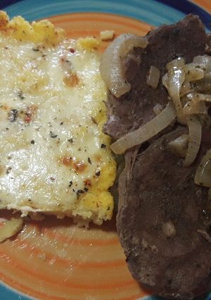 Una foto de Bifes encebollados con polenta al horno