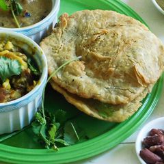 A picture of Lunch is served: South Indian Thali with Potato Masala puri, Kidney Beans Koottu, and Green Chutney.