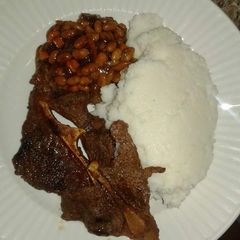 A picture of Wet Fried Beef, stewed beans with Ugali.