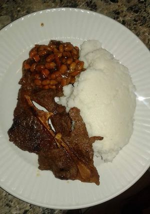 A picture of Wet Fried Beef, stewed beans with Ugali.