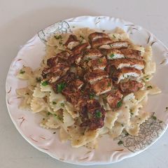 A picture of Cajun Chicken and Farfalle Alfredo Pasta.
