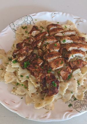 A picture of Cajun Chicken and Farfalle Alfredo Pasta.