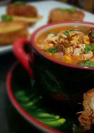 A picture of Chicken fajita soup with chicken pin rolls and cheesy potatoes.