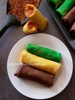 A picture of Flavoured Rolled Crepes with Toasted Coconut Filling.
