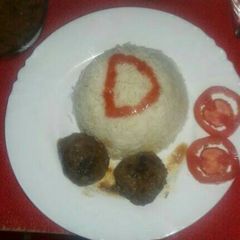A picture of Meatballs with rice& stew.