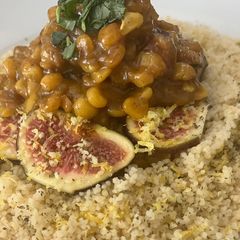 A picture of Ouzo marinated figs with chickpeas and couscous.