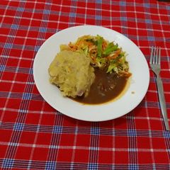 A picture of Ginger mashed Green banana(matoke) Beef stew cabbage and carrots.