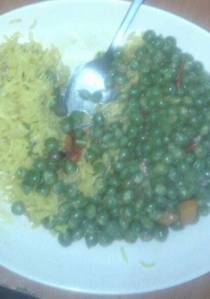 A picture of Tumeric rice served with peas.
